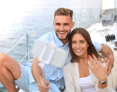 A couple taking a selfie on a yacht in Puerto Vallarta after a marriage proposal.