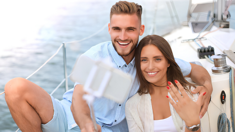 A couple taking a selfie on a yacht in Puerto Vallarta after a marriage proposal.