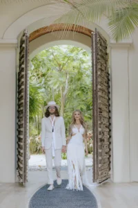 Beautiful beachfront villa setup for a wedding ceremony in Mexico, showcasing the stunning view and elegant decorations. The wedding couple is shown at the entrance of a luxury villa.