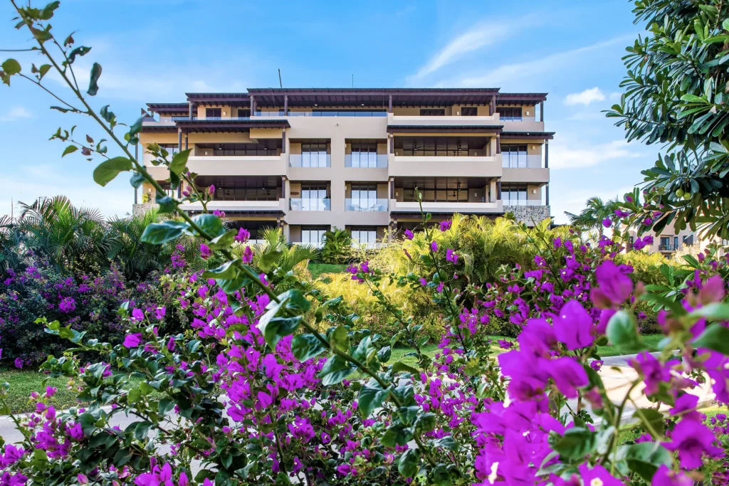 PH Prima Vista front view of a multi-storey building beyond dense purple bougainvillea — Punta Mita Nayarit, Mexico