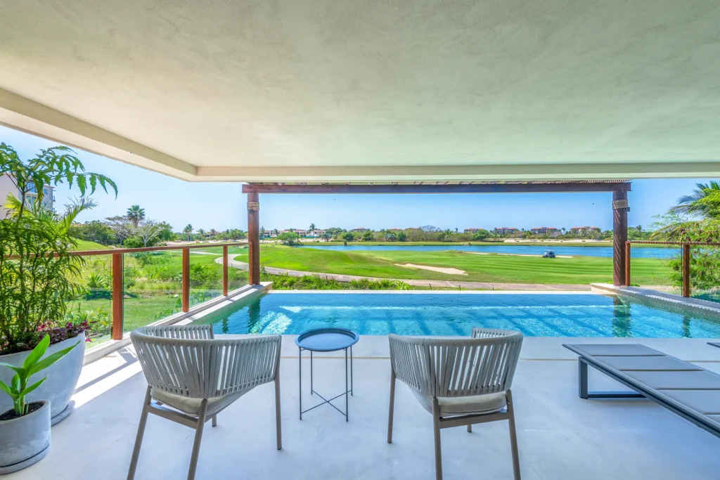 Condo Allegra two gray chairs and black table beside the pool and fairway — Punta Mita Nayarit, Mexico