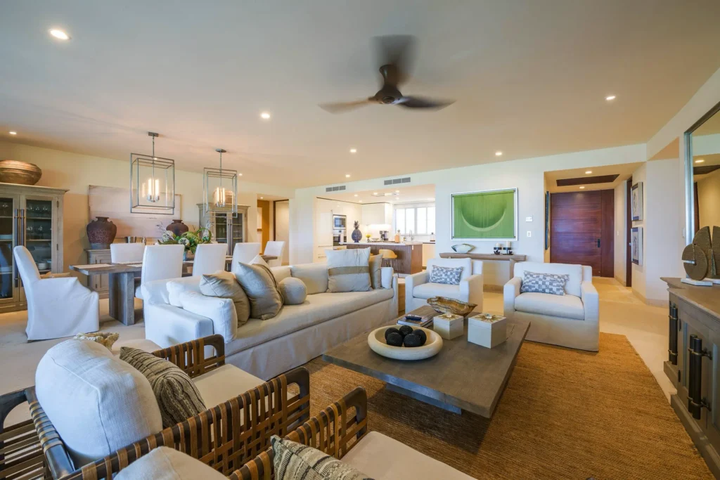 Condo Ginger open living room, dining table and white kitchen beneath lantern pendants — Punta Mita Nayarit, Mexico