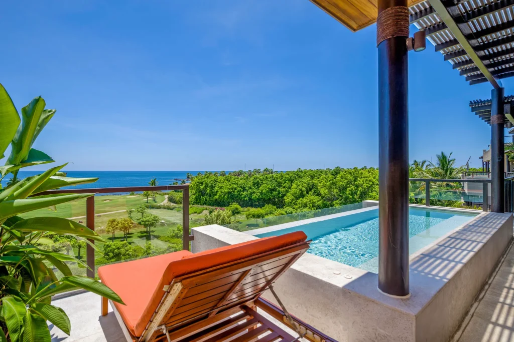 Condo Joya orange chaise beside the plunge pool with a fairway and ocean view — Punta Mita Nayarit, Mexico