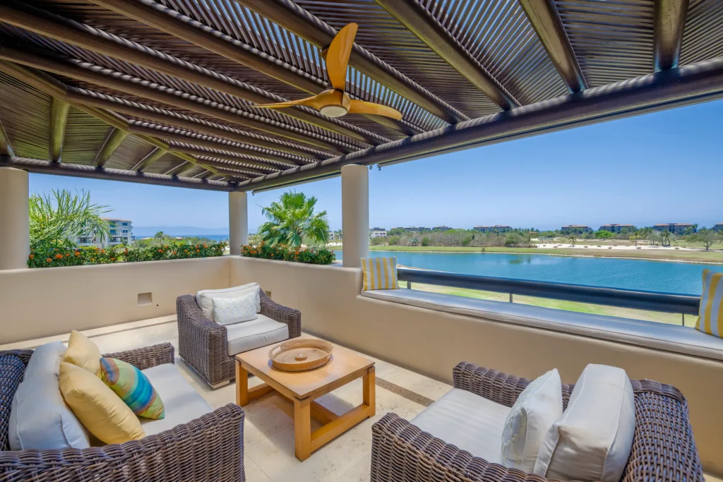 Condo Lago covered wicker seating beneath slatted roof overlooking pond — Punta Mita Nayarit, Mexico