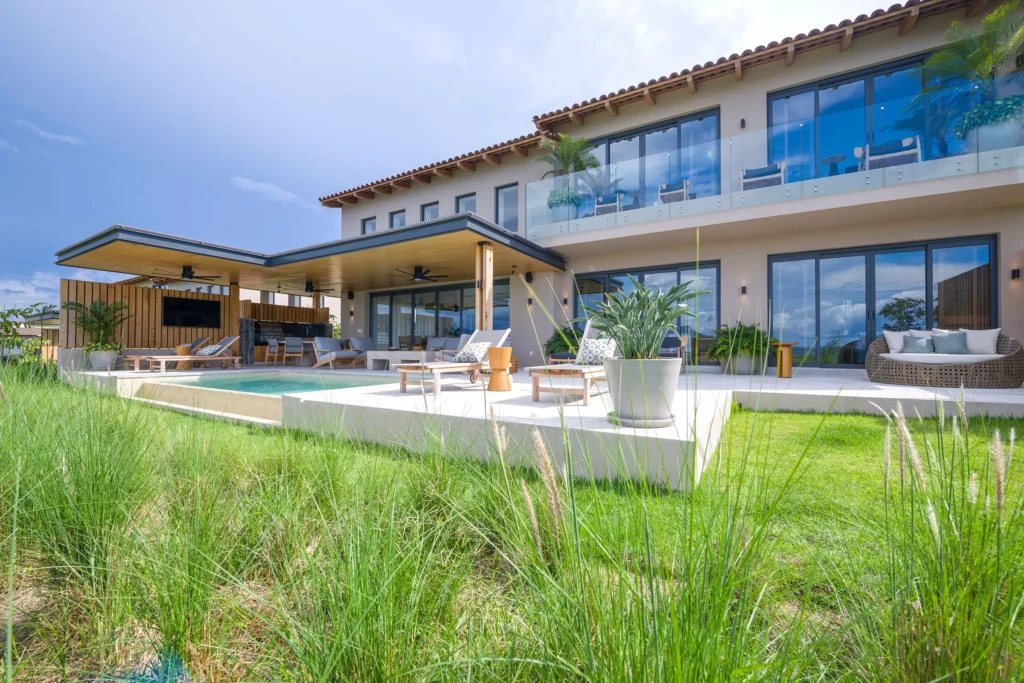 Villa Cielo Azul two-story facade and patio beneath a cloudy sky — Punta Mita Nayarit, Mexico