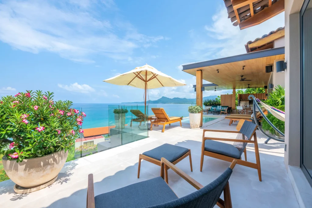 Villa Coco terrace chairs and hammock beside flowers above the sea — Punta Mita Nayarit, Mexico