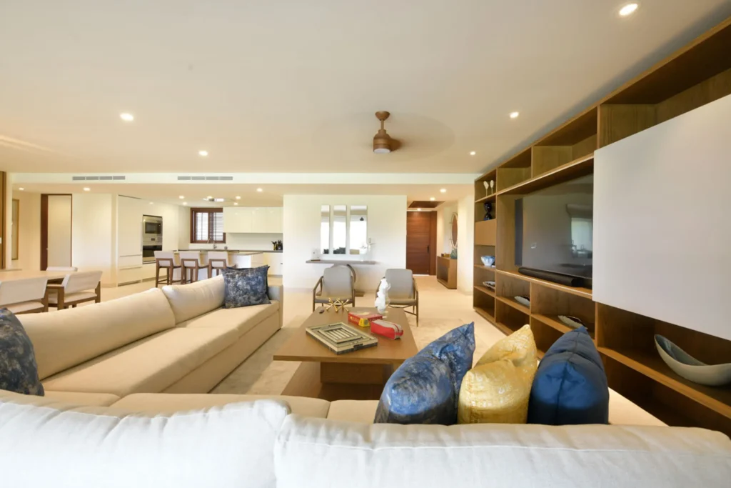 Condo Silver living room with a sectional sofa, accent pillows and media wall — Punta Mita Nayarit, Mexico