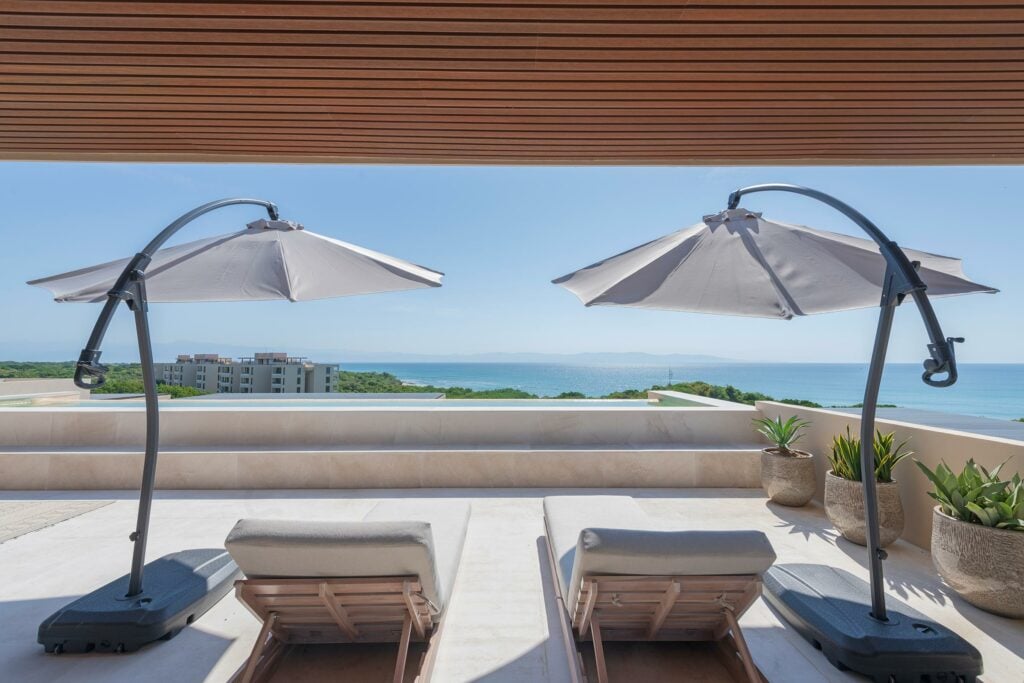 Penthouse Oasis two loungers beneath curved umbrellas facing the ocean — Punta Mita Nayarit, Mexico