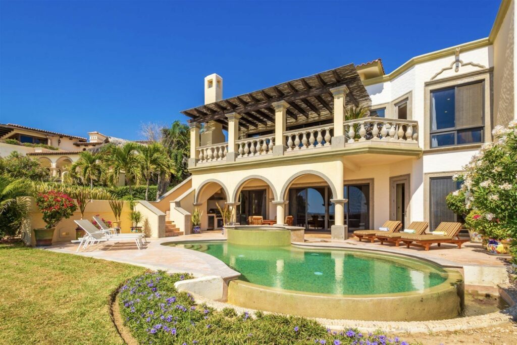 Villa Mariposa the two-storey rear elevation and pergola above the pool and lawn — Los Cabos, Mexico