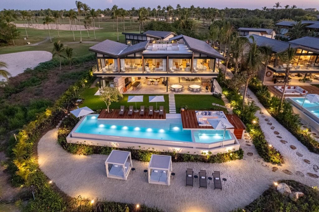 Villa Punta Pacifico Norte aerial dusk view of the illuminated villa, pool and garden path — Punta Mita Nayarit, Mexico