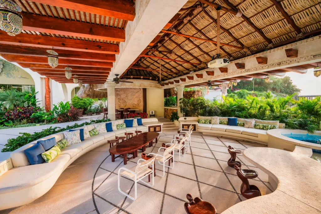 Outdoor lounges arranged towards the sunset above the bay