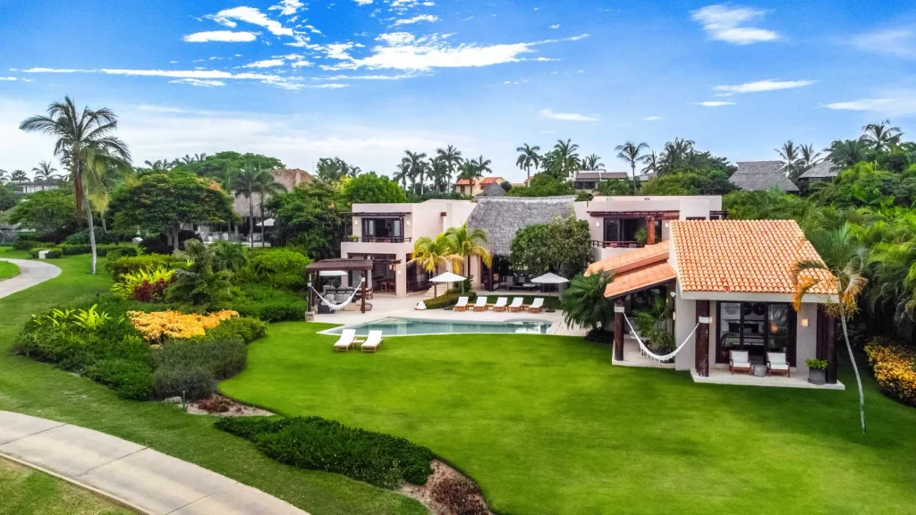 Casa Caida de Agua aerial view of the villa, curved pool, lawn and gardens — Punta Mita Nayarit, Mexico