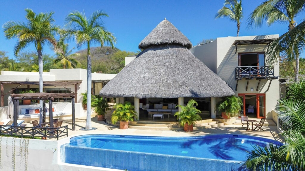 Casa Caracol the conical thatched roof above the pool and planted terrace — Punta Mita, Mexico