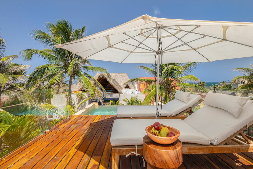 Casa Romeo a bowl of fruit between loungers on the deck beside the pool — Tulum, Mexico