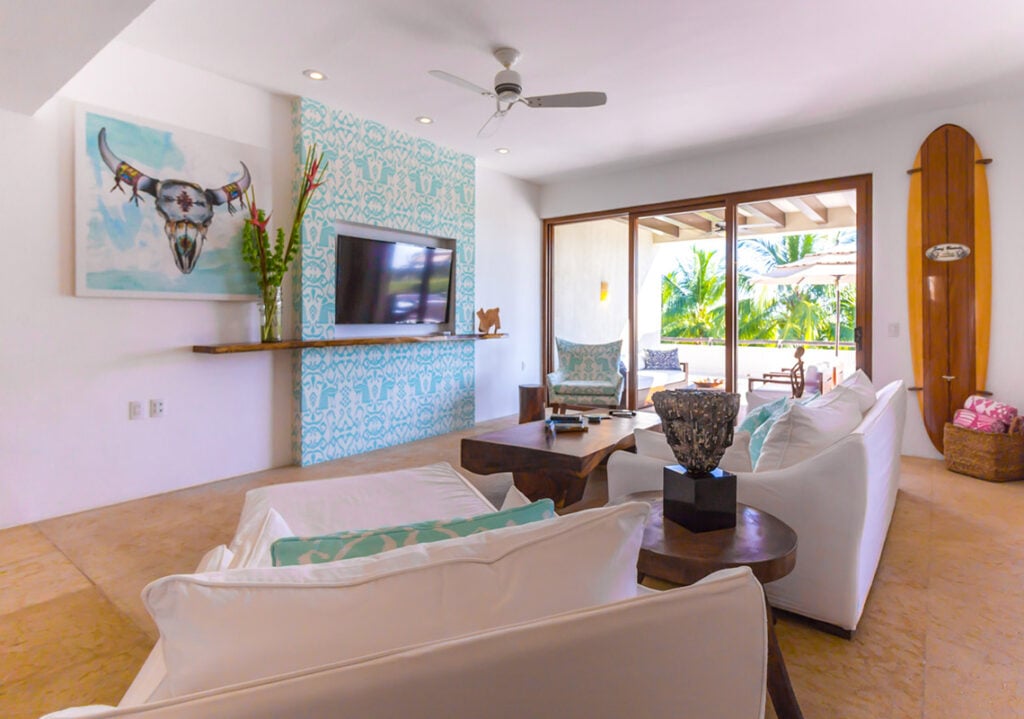 Condo Terrazas B32 a bull-skull painting and surfboard beside the terrace doors — Punta Mita, Mexico