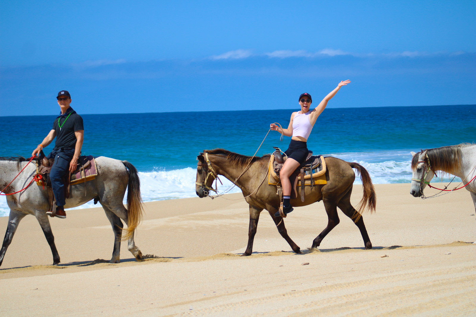 Horseback riding on secluded Pacific beach with desert backdrop sunset Cabo San Lucas