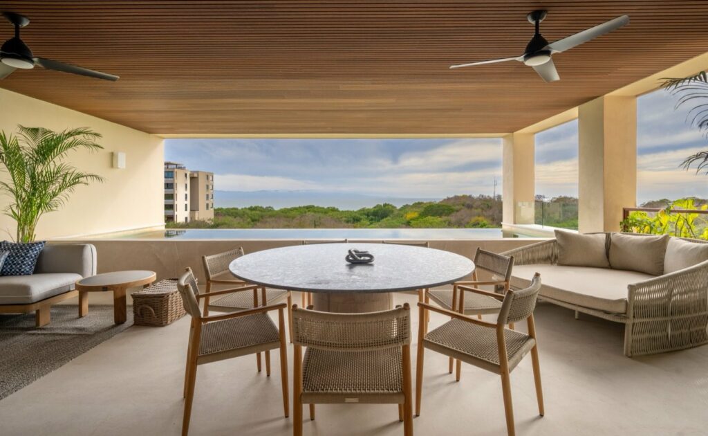 Surf Residences 221 covered terrace with a round table between two sofas — Punta Mita Nayarit, Mexico