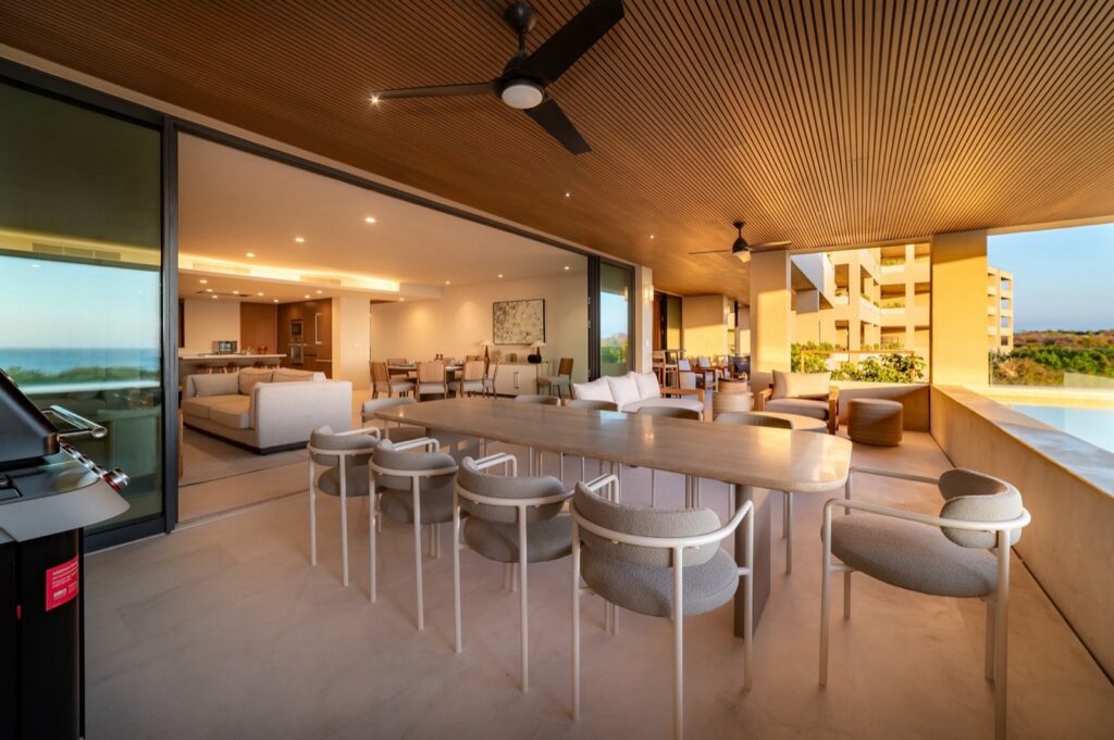 Surf Residences 312 covered terrace dining table beside the pool and living area — Punta Mita Nayarit, Mexico