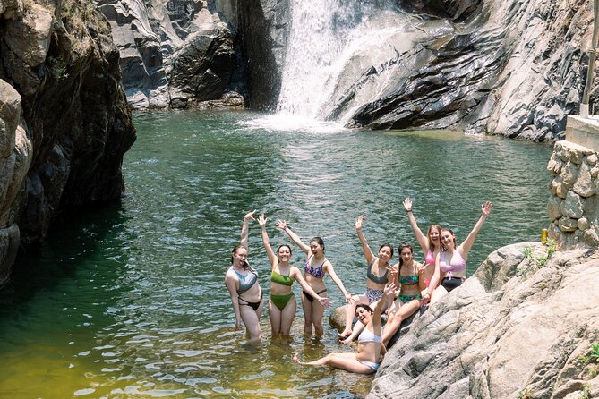 Jungle waterfall cascading into natural swimming pool surrounded by tropical forest near Puerto Vallarta