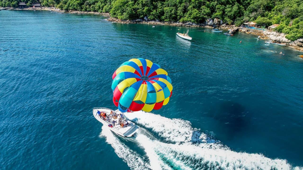 Vallarta parasailing adventure with panoramic bay views and mountain backdrop