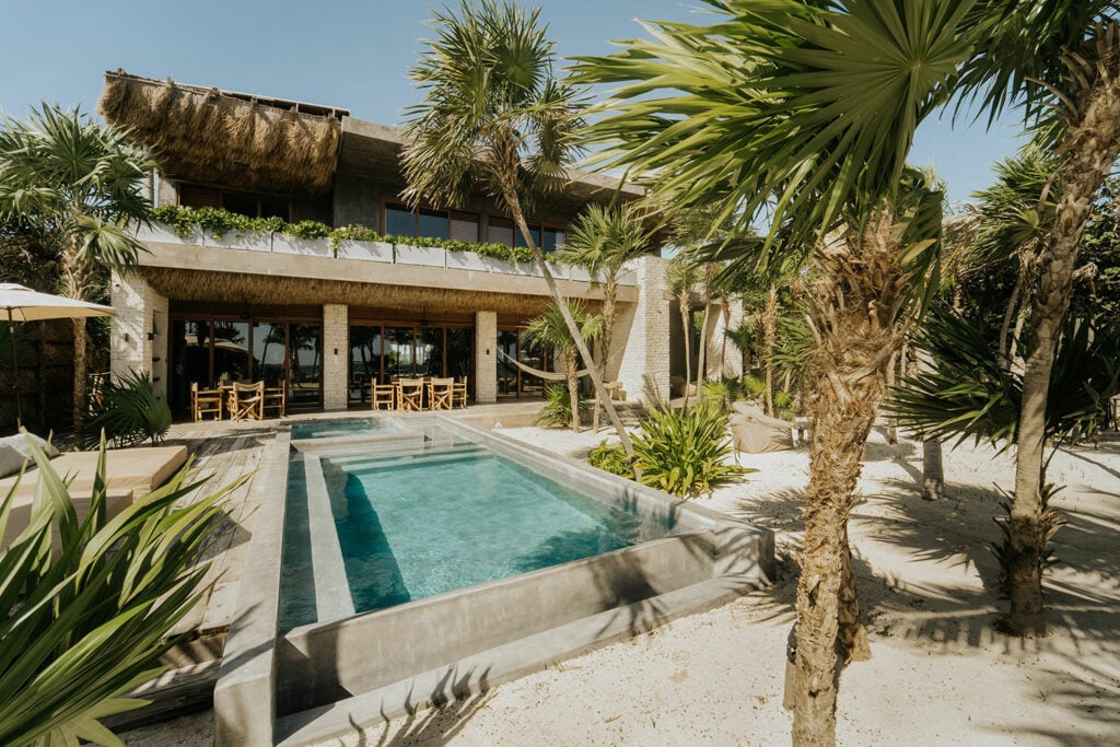 Villa Moloch private pool with palapa roof and palm trees — Soliman Bay Tulum