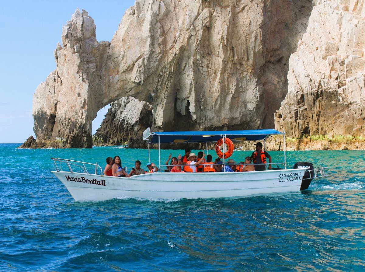 Water taxi approaching Lovers Beach through El Arco with sea lion colony Cabo San Lucas
