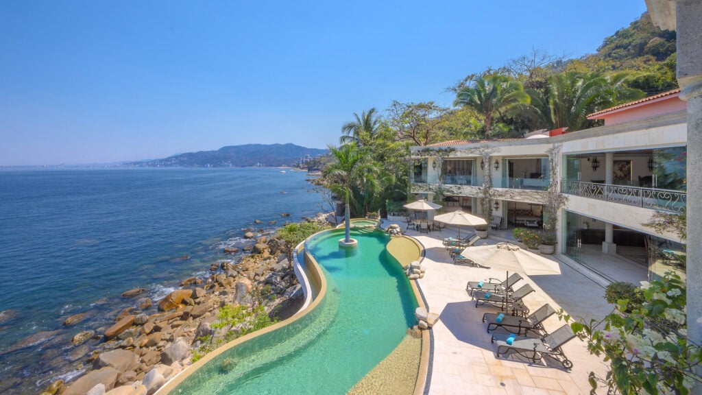 Casa Michael aerial view of the pool and rocky shoreline — Puerto Vallarta, Mexico