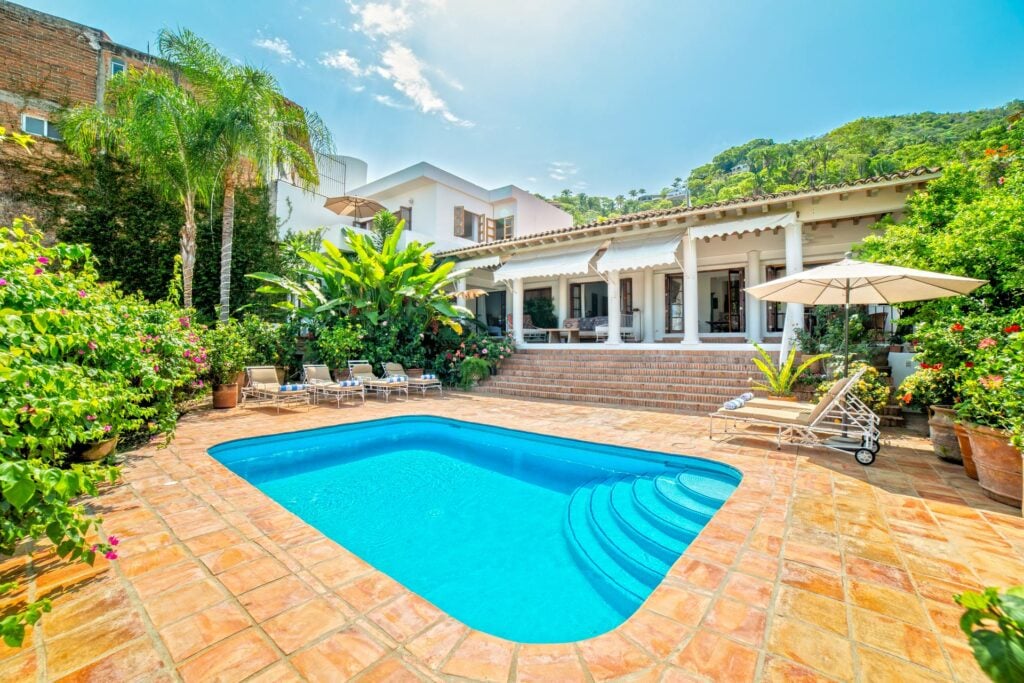 Villa Veranda blue pool and stepped terrace surrounded by flowering plants — Puerto Vallarta, Mexico