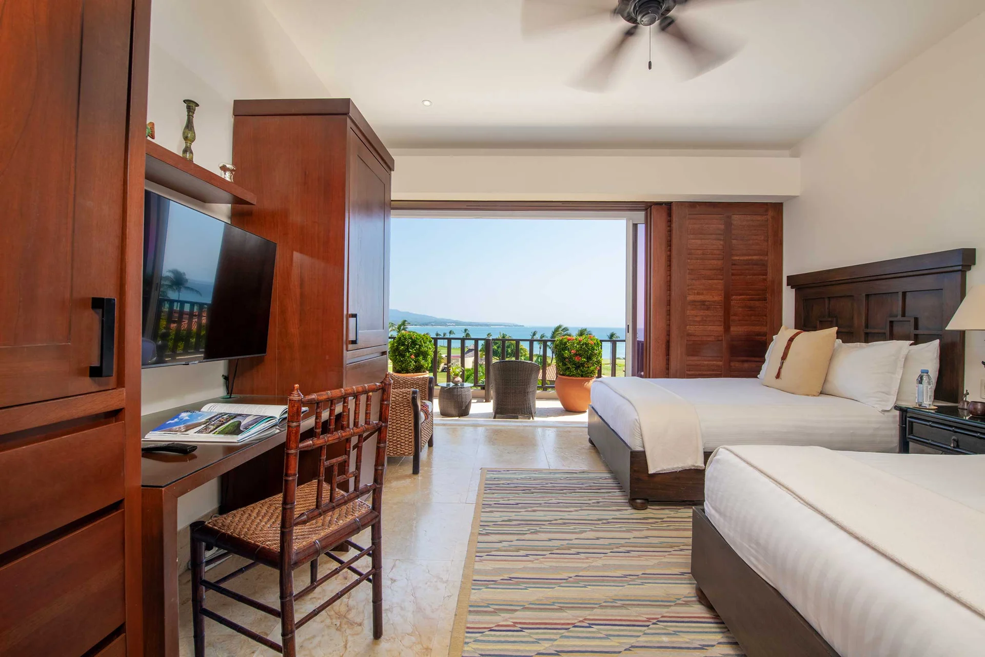 PH Vista Encanto guest bedroom with two queen beds, desk and terrace doors — El Encanto, Punta Mita