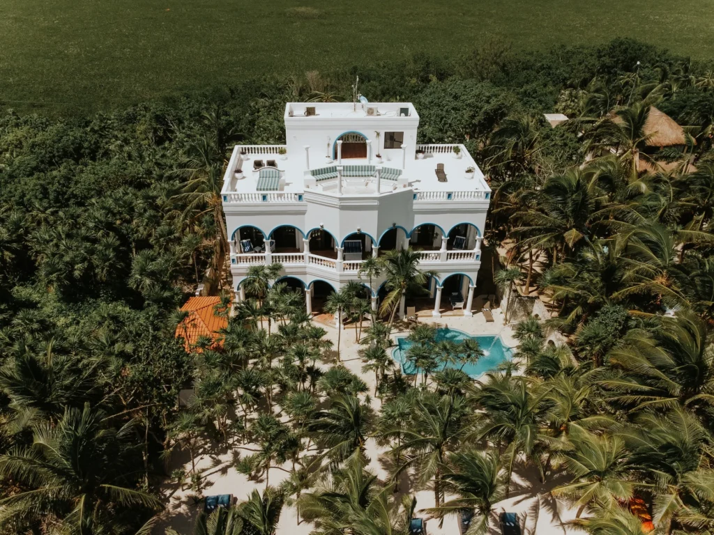 Casa Priakos and its pool among the palms above Soliman Bay, seen from the air