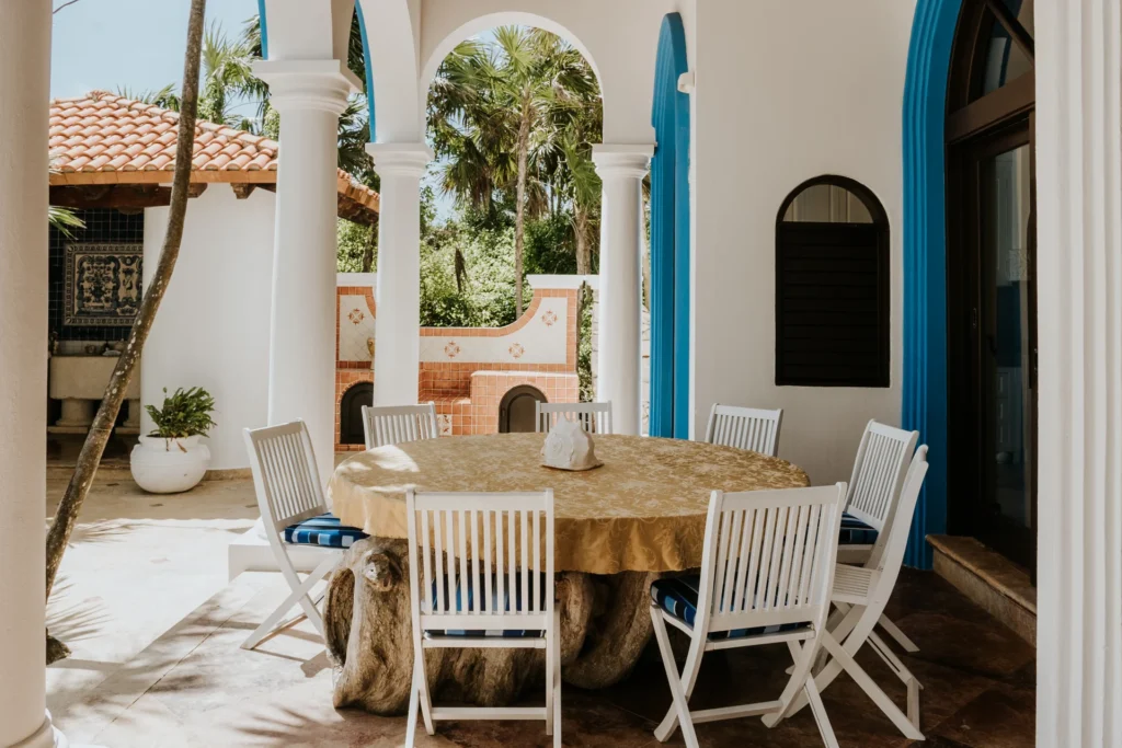 The outdoor dining terrace at Casa Priakos, the table laid under the arches