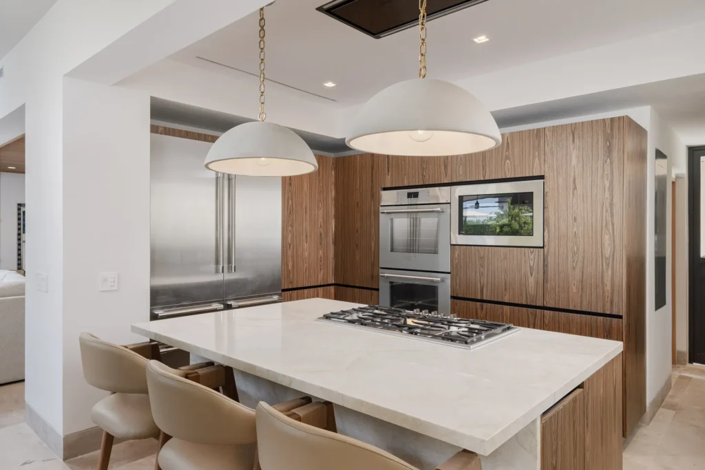 A villa kitchen with an island, a cooktop and pendant lights — Villa Buena Vida, Porta Fortuna
