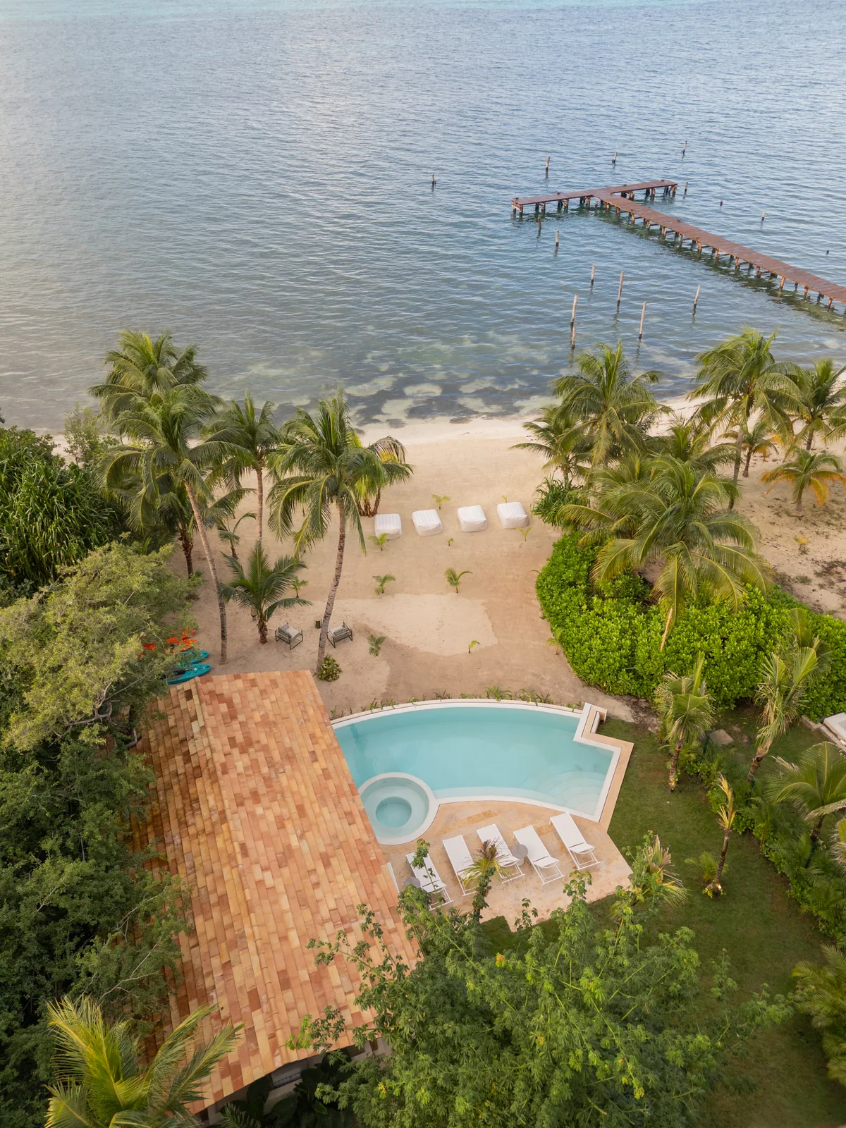 Aerial view of the dock, the beach and a residence pool at La Colección Residences, Isla Mujeres