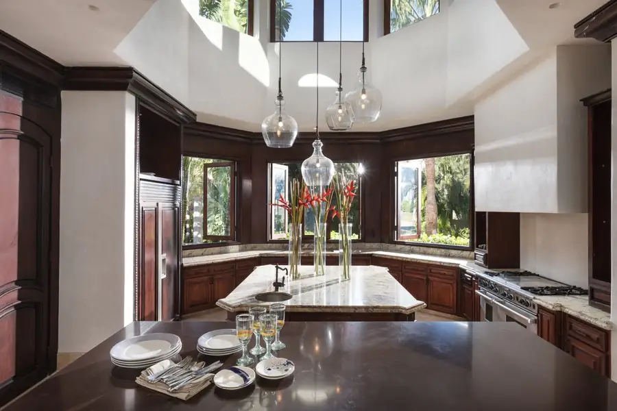 The kitchen at Casa La Vida with a central island under glass pendant lights