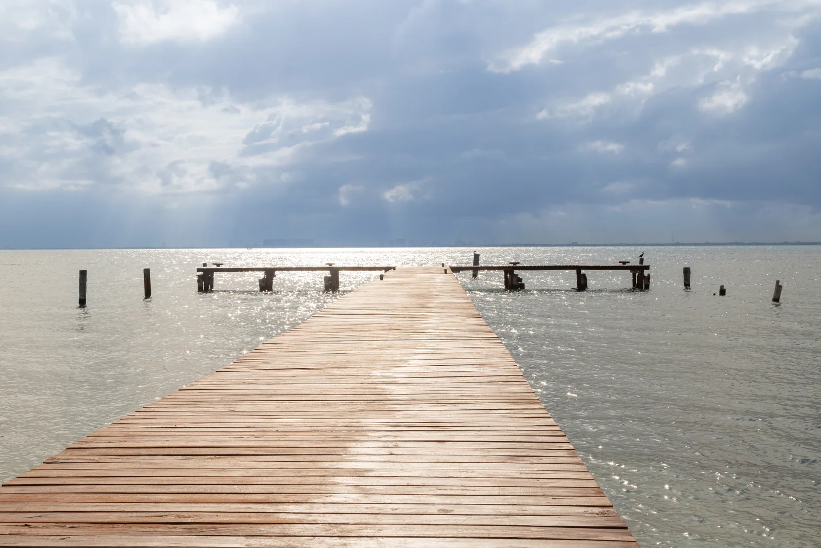 The private dock stretching into the calm Bahía de Mujeres at first light, Isla Mujeres