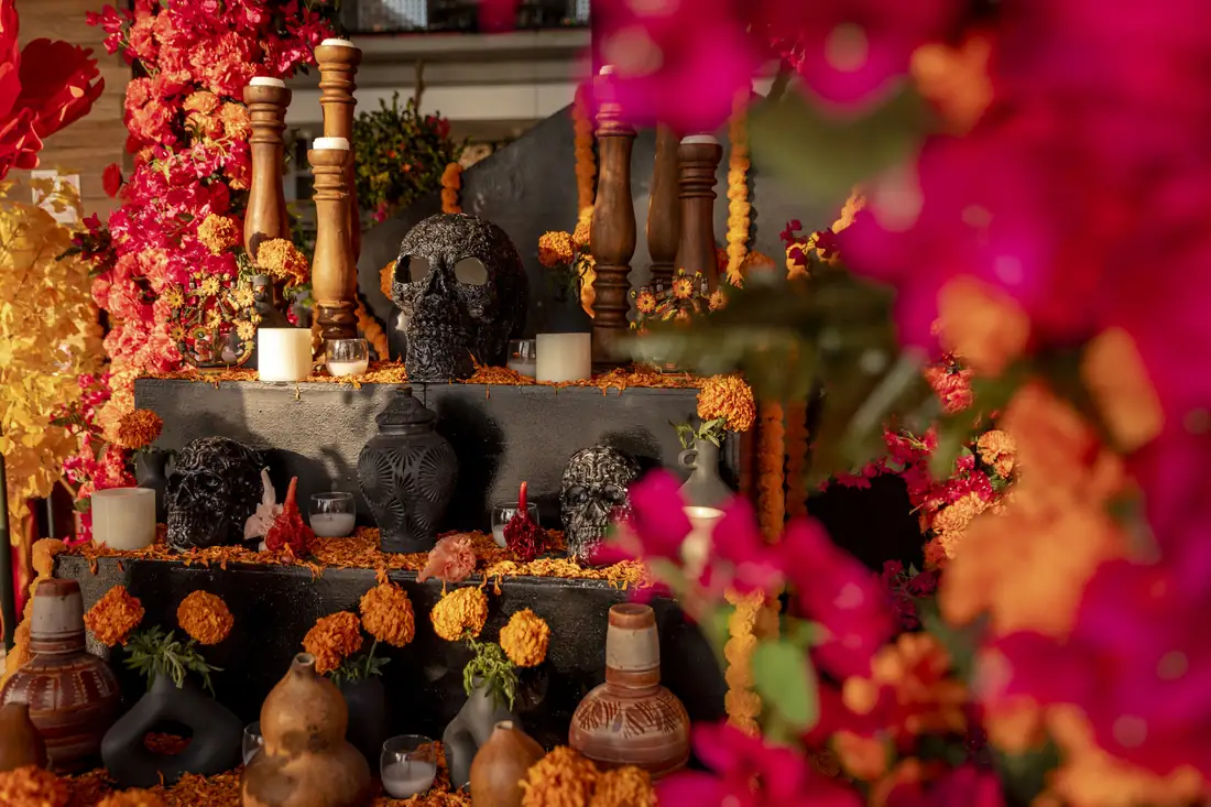 A Day of the Dead altar with marigolds, bougainvillea and skulls at Dos Catrinas, Four Seasons Punta Mita