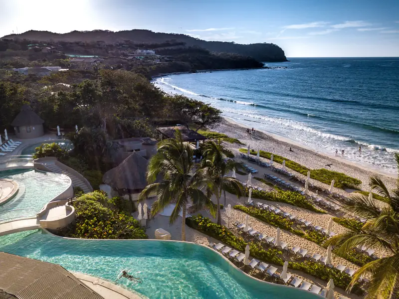 Aerial view of the pool and beach at Kupuri Beach Club, Punta Mita