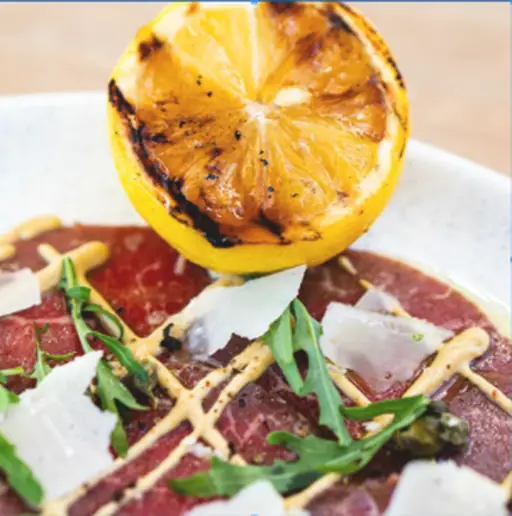 A plate of carpaccio at Marea, the Italian restaurant at Kupuri Beach Club