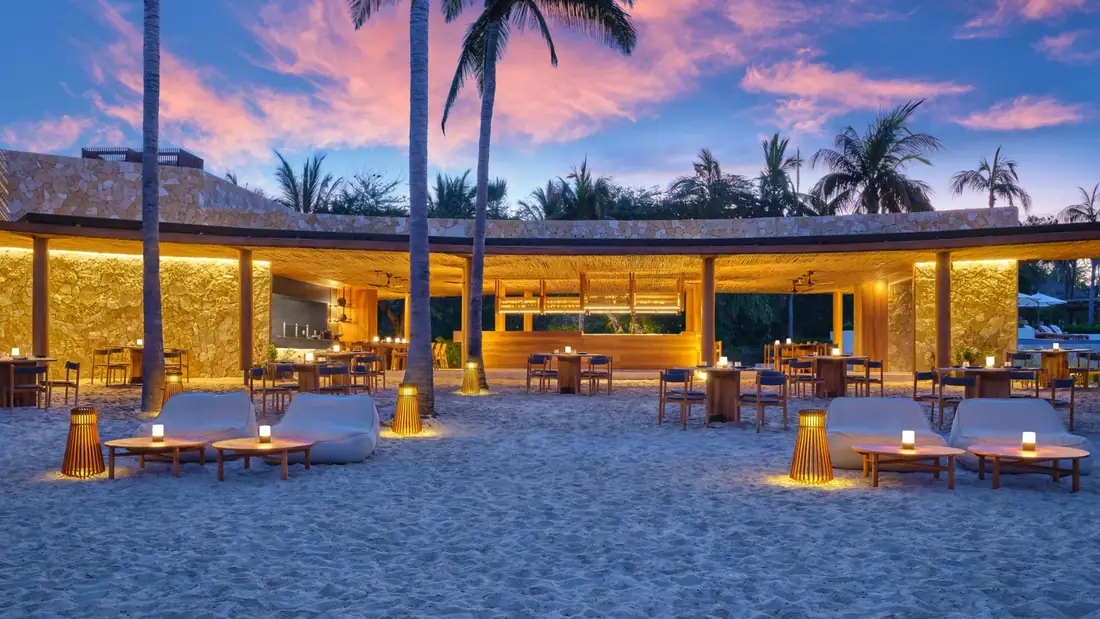 Mita Mary's tables on the sand at dusk at The St. Regis Punta Mita
