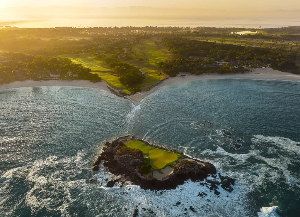 Aerial view of the Tail of the Whale, a golf green on a rock island off Punta Mita, with the Pacífico course and beach behind