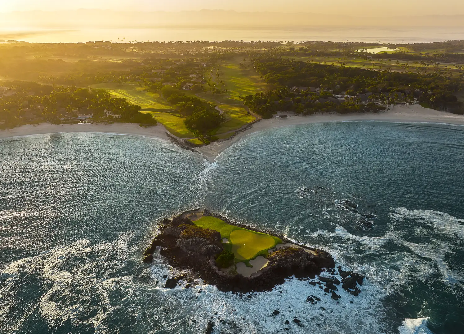 Aerial view of the Tail of the Whale, a golf green on a rock island off Punta Mita, with the Pacífico course and beach behind