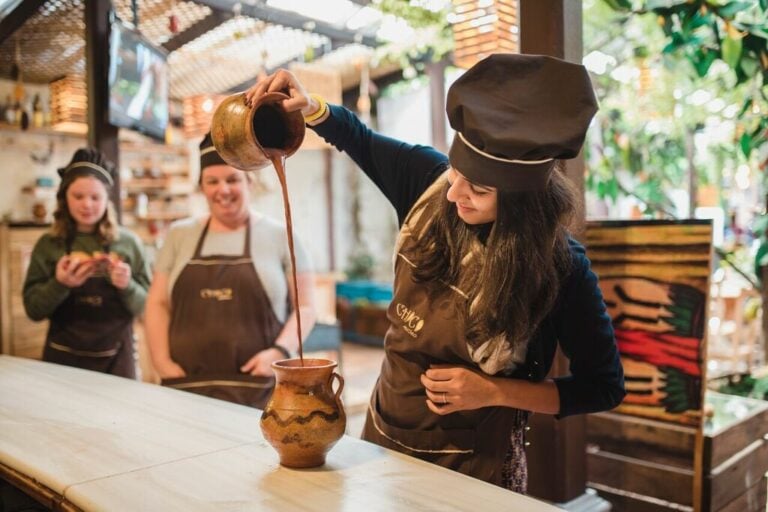 Staff pouring traditional hot chocolate in the Puerto Vallarta workshop