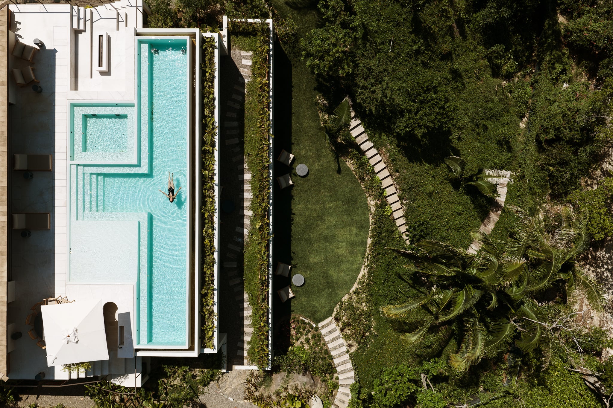 Villa Taiyari pool and terrace from above, beside the lawn and the stepping-stone paths through the garden — Punta Mita Nayarit, Mexico