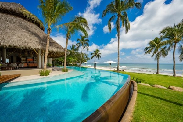 A luxurious beachfront villa in Mexico with a stunning ocean view and private pool.